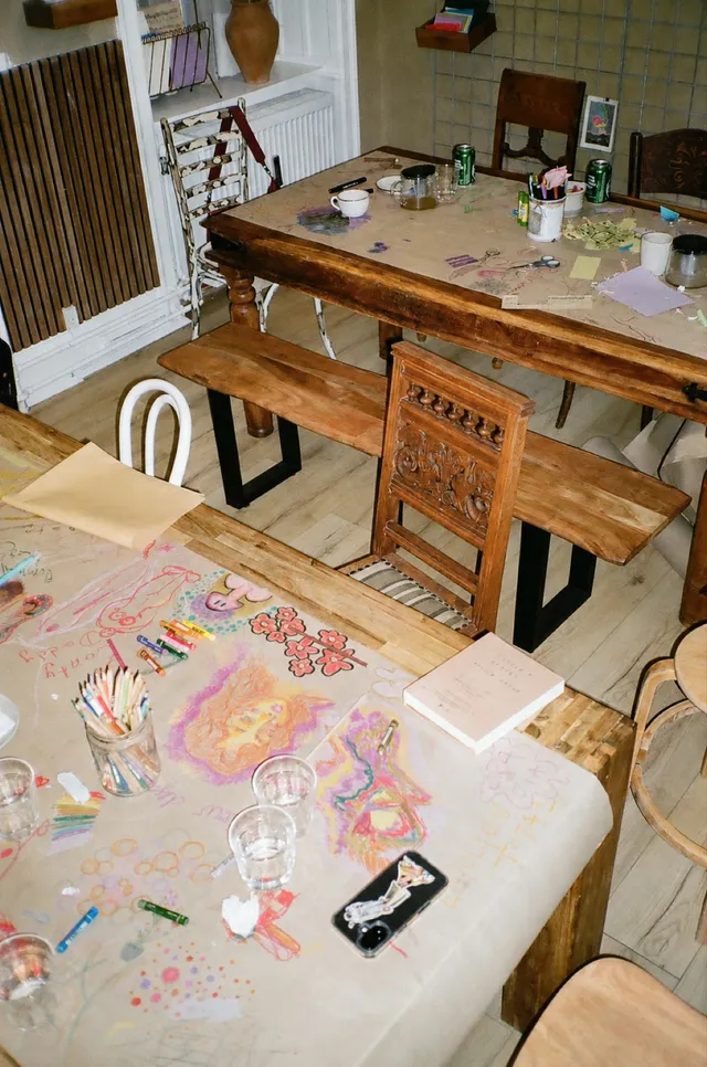 A table covered in paints and works in progress