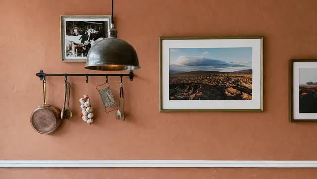 Copper pots hanging on the terracotta wall