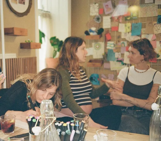 A crowded table at a creative workshop